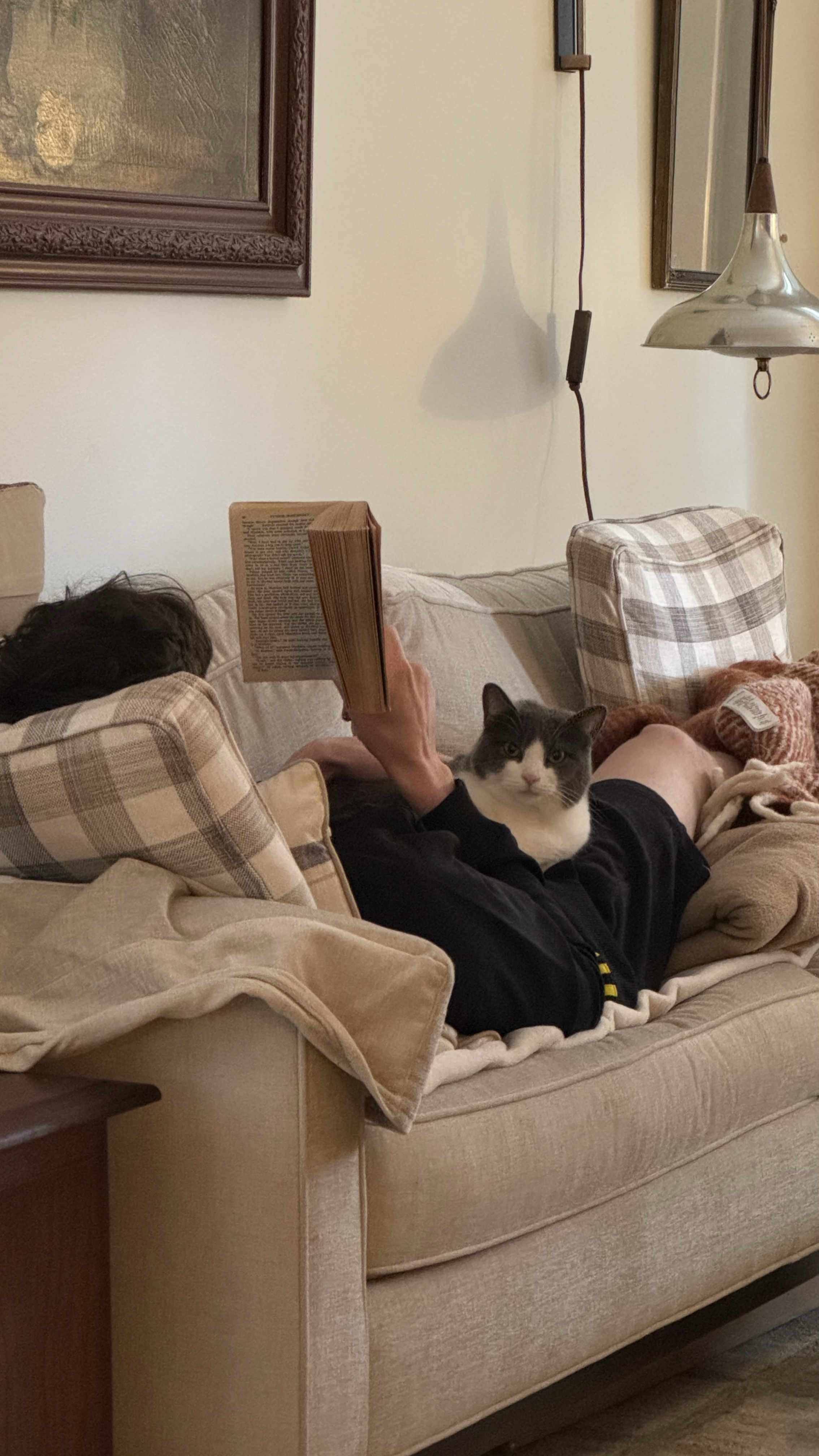 Kai reading with his cat